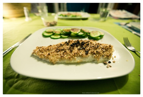 grilled fish topped with mustard and oats